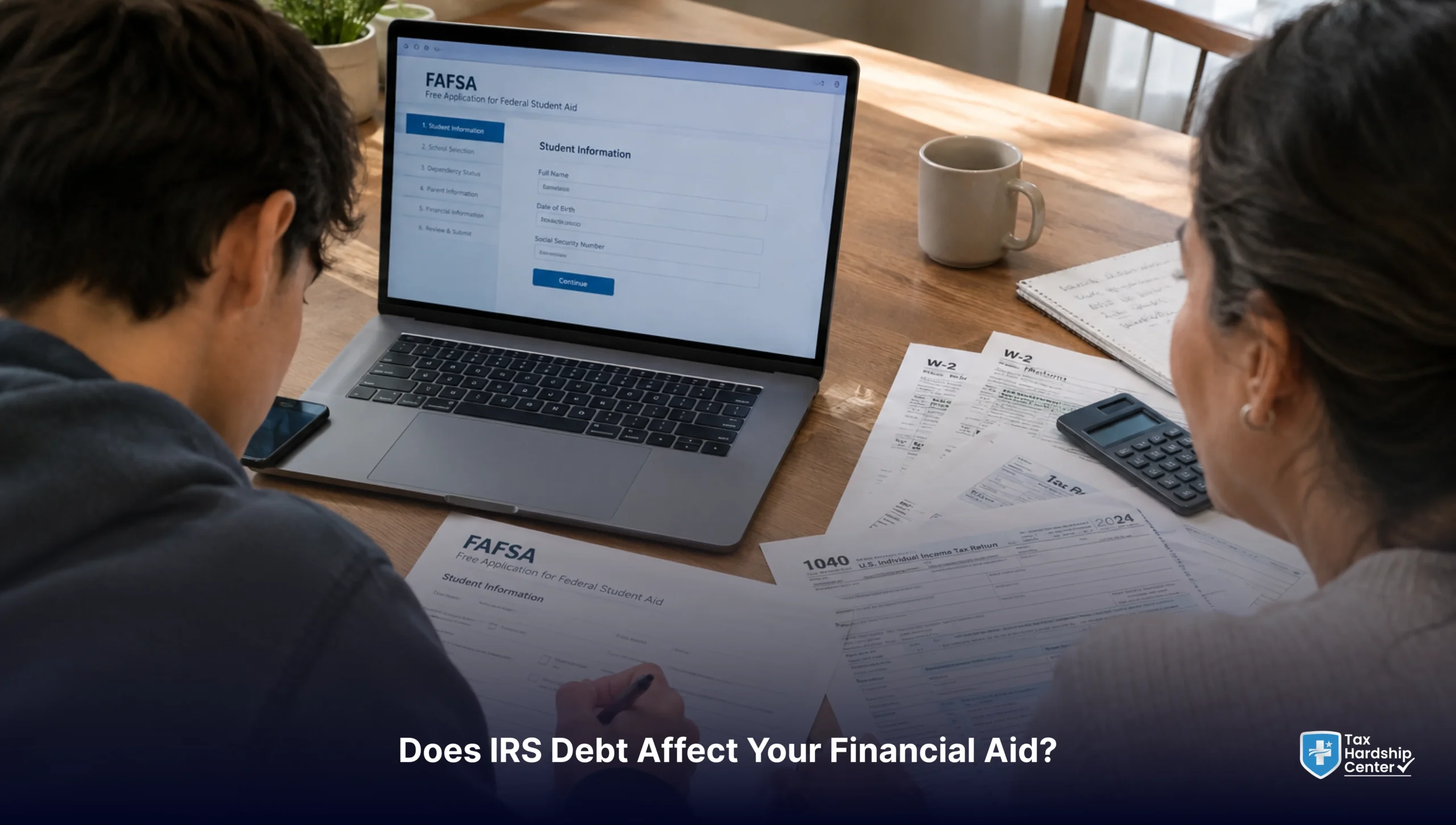 Student and parent completing FAFSA with tax documents and IRS debt paperwork